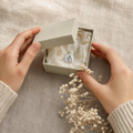 Evercarry gift box with pendant inside on linen